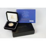 A Royal Mint United Kingdom 2005 gold proof full sovereign coin, encapsulated and set within black