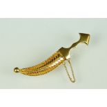 Yellow metal brooch modelled as a sabre with filigree scabbard, hinged pin and simple loop brooch