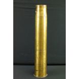 A British military inert brass artillery shell, broad arrow marked to base and dated 1940.