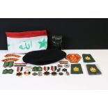 A collection of Iraq military collectables to include flag, badges, cloth patches, medals, cap...