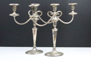 Pair of 'Yeoman' silver plated twin-branched candelabra, with swept reeded branches, raised upon