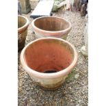 Pair of large terracotta planters, of tapering circular form, with relief garland decoration, each