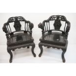 Pair of Chinese Hardwood Tub Chairs, elaborately carved with dragon arms supported by figures, the