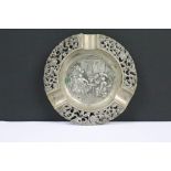 A fully hallmarked sterling silver ashtray with central repouse bar scene and outer pierced