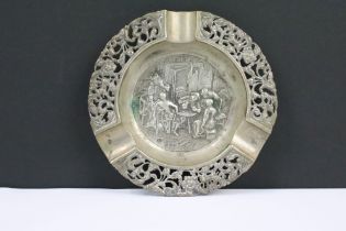 A fully hallmarked sterling silver ashtray with central repouse bar scene and outer pierced