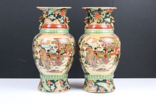 Pair of Japanese baluster vases enamel decorated with figural panels and floral decoration on a blue