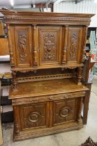 19th century Carved Oak Gothic Cabinet, the upper structure with three carved panel doors, all