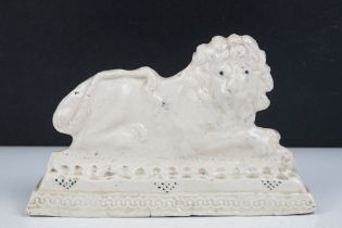 Early 20th Century ceramic lion flat back figurine, depicted crouched on a moulded base. Signed Lily