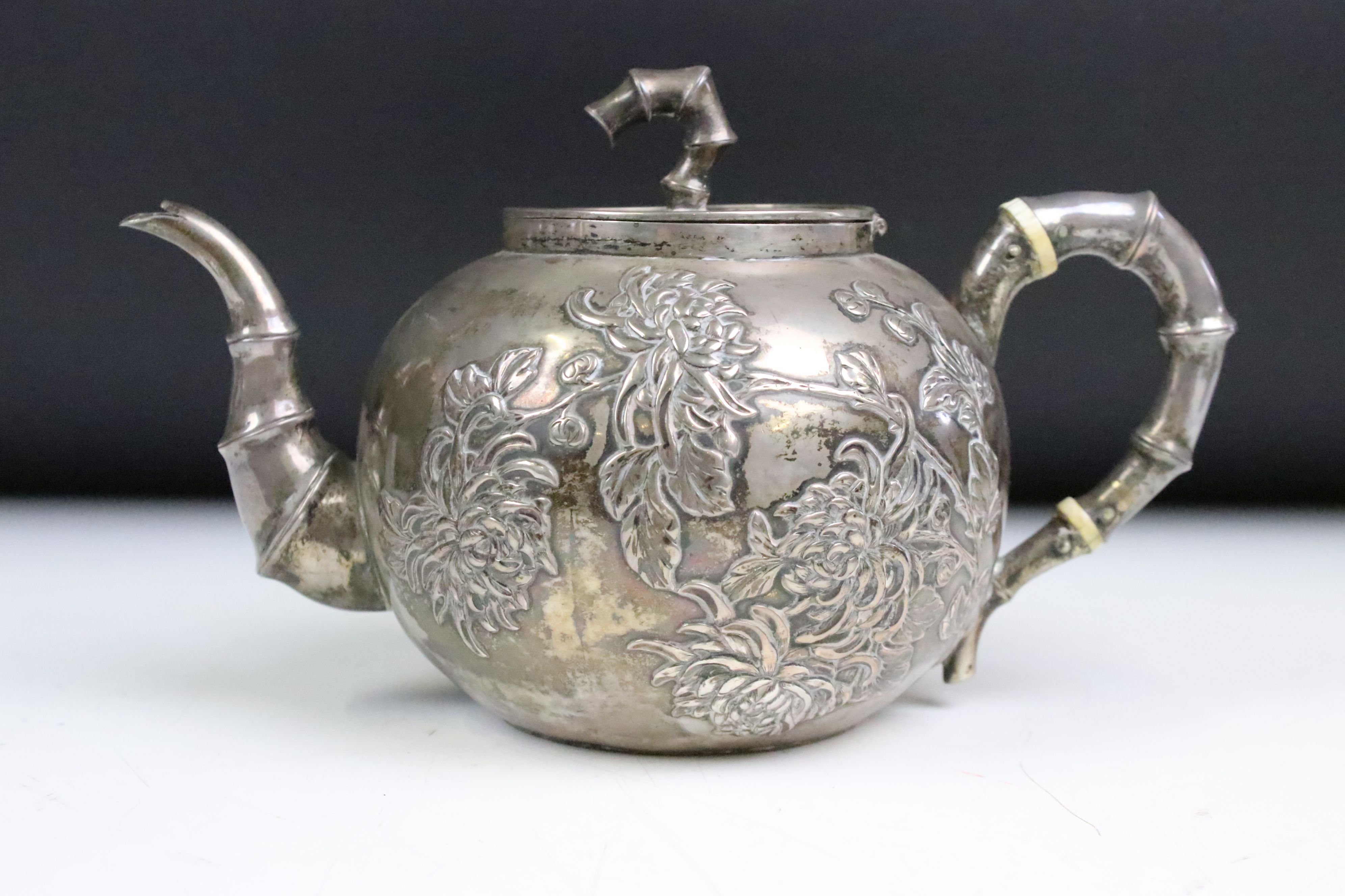 An antique Chinese silver teapot cast with cherry blossom decoration and bamboo style handles and - Image 2 of 8