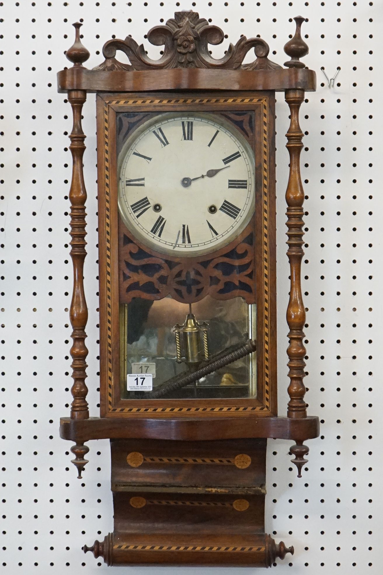 Edwardian inlaid mahogany pendulum wall clock having a round face with roman numerals to the dial,