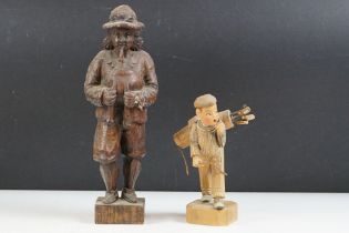 Carved oak black forest style figure depicting a piper, together with a 1930's carved wooden novelty