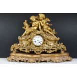19th Century gilt metal mantle clock having a central white enamelled face with roman numerals to