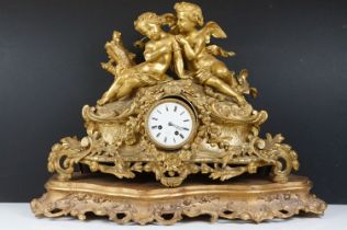 19th Century gilt metal mantle clock having a central white enamelled face with roman numerals to