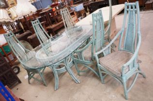 Large Conservatory Dining Table, the oval glass top supported by a green painted wicker base,