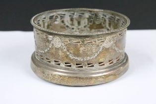 A fully hallmarked sterling silver bottle coaster, assay marked for Chester and dated for 1912.
