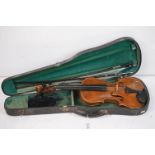 A violin together with two violin bows, cased, label suggests this was possibly the property of