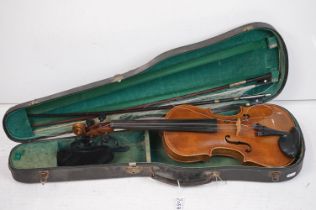 A violin together with two violin bows, cased, label suggests this was possibly the property of