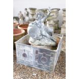 Large lead garden water feature modelled as a putti draped in grapes resting on a barrel, holding