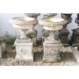 Pair of reconstituted stone garden urns, the bowls of shallow form, with ovolu-moulded rims and