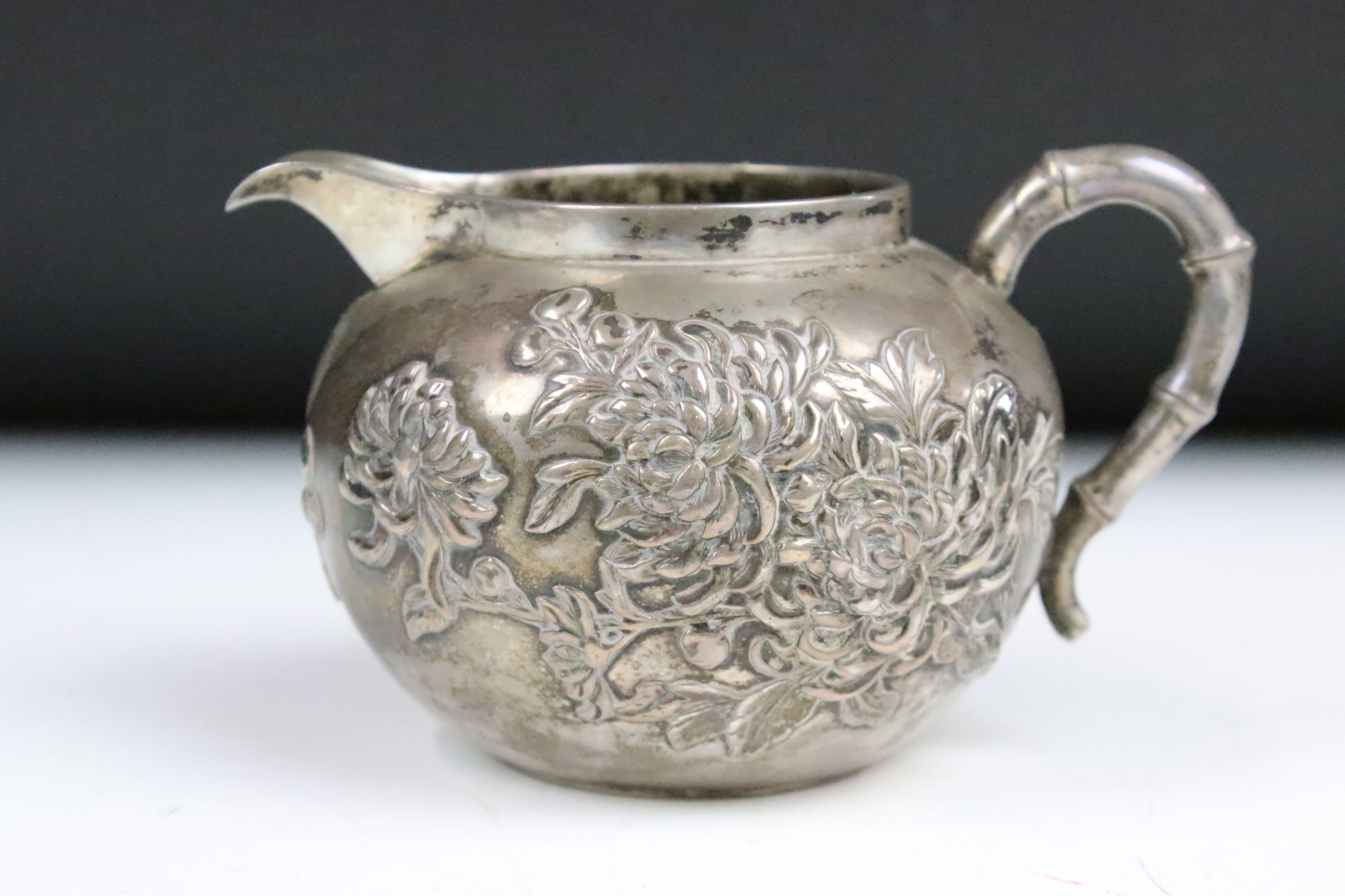 An antique Chinese silver teapot cast with cherry blossom decoration and bamboo style handles and - Image 6 of 8