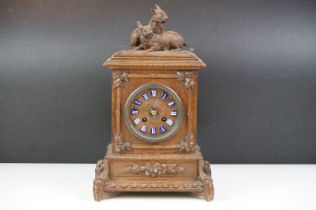 19th Century Victorian carved black forest mantle clock featuring carved rabbits to the top, and