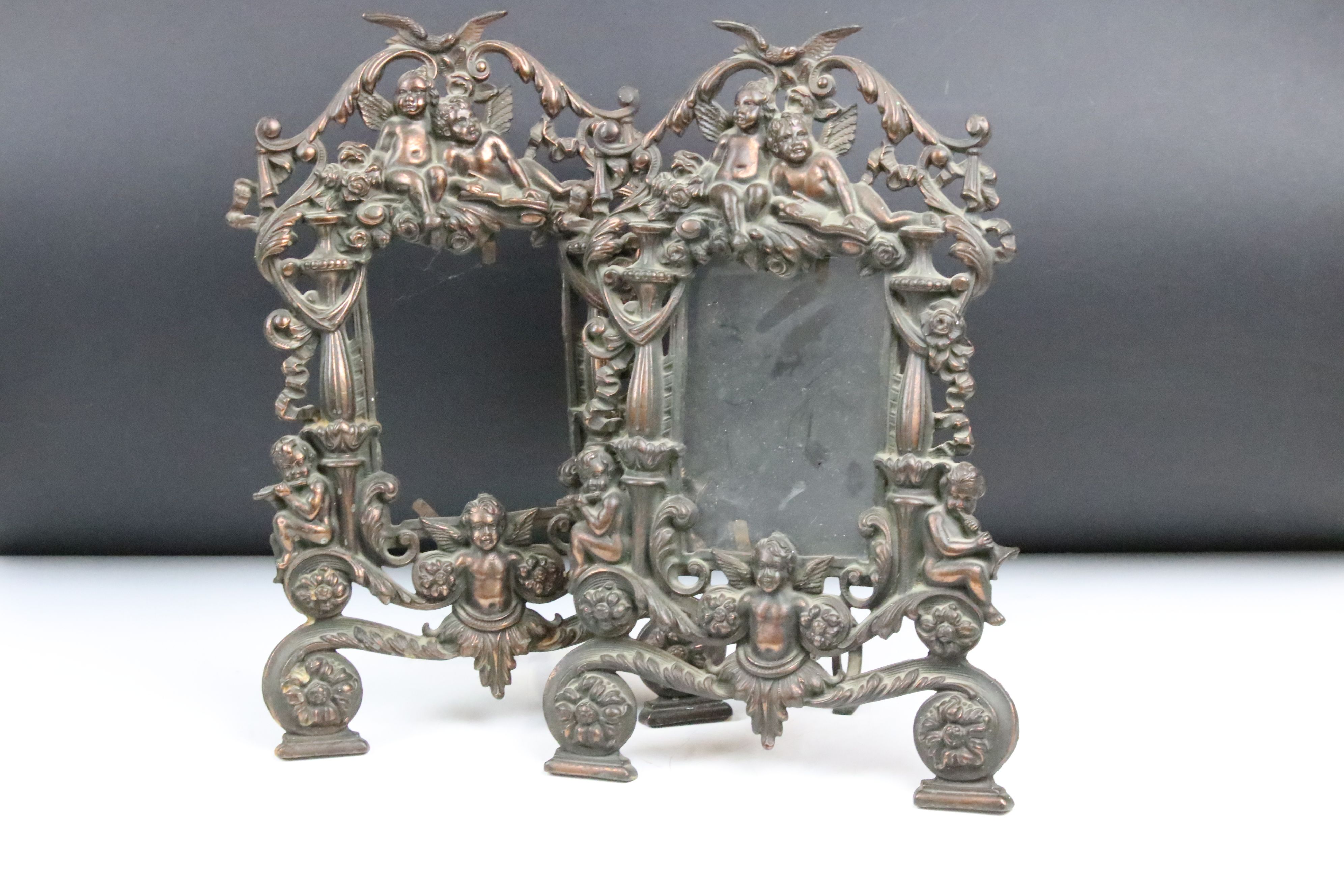 Pair of 19th century cast iron bronze-effect photograph frames, pierced and decorated with putti &