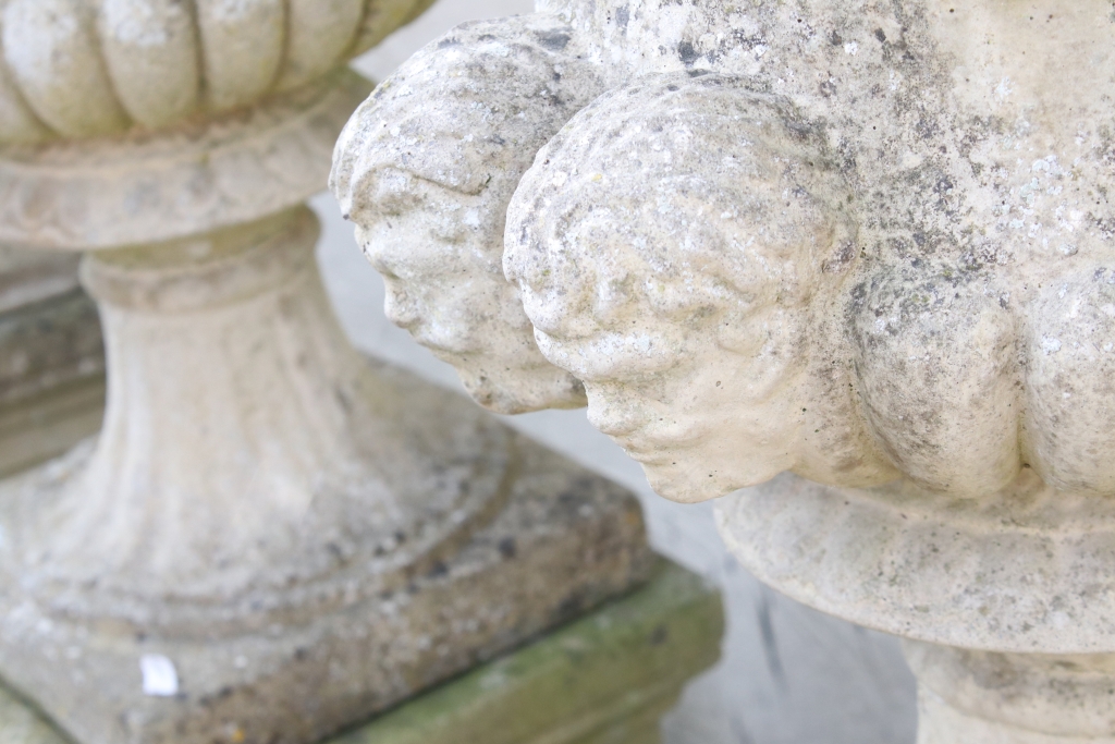 Pair of reconstituted stone garden urns of campana form, with relief facial mask decoration and - Image 4 of 5