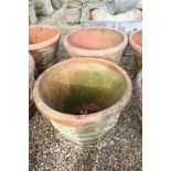 Pair of large terracotta planters, of tapering circular form, with relief garland decoration, each