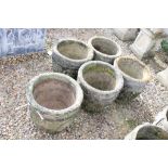 Set of five reconstituted stone garden planters, of circular form with grape and scrolling