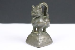 An antique bronze Burmese opium weight, stands approx 73mm in height.