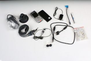 A vintage Sony Ericsson mobile phone together with accessories contained within a Nokia box.