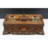 Early 20th Century Edwardian carved oak ink stand having carved foliate detailing with an armorial