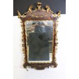 Italian style Walnut and Parcel Gilt Mirror in the 18th century manner with moulded foliate and
