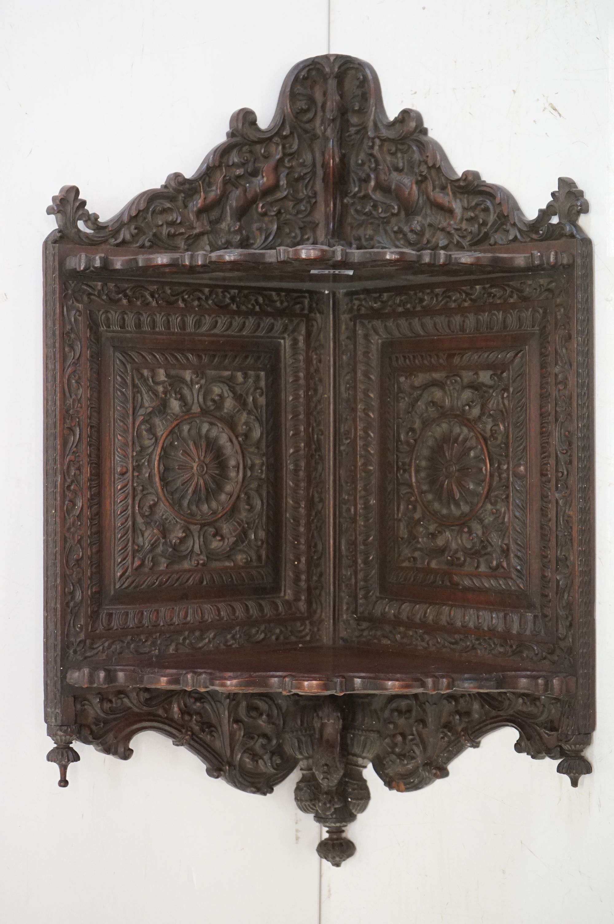 19th century Anglo Indian Hardwood Hanging Corner Shelf, profusely carved including lions, deer, a