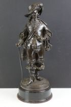 Cast bronze statue of a 17th century noble gentleman with with sword and cane, raised on an ebonised