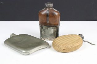 A group of three early 20th century hip flasks to include pewter and silver plated examples.