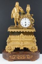 19th Century French gilt mantle clock having a gilt male figure to the top beside a white