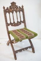 Victorian Walnut Carved Folding Chair, the cresting rail carved with two dolphins or fish beneath