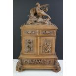 Early 20th Century Black Forest carved walnut dressing table cabinet, headed by a pheasant & chick