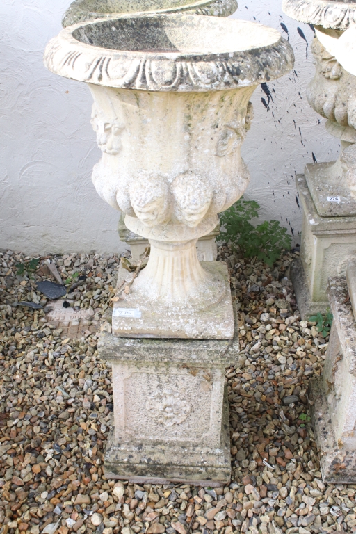 Pair of reconstituted stone garden urns of campana form, with relief facial mask decoration and - Image 2 of 5