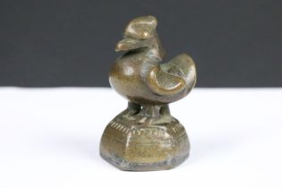 An antique bronze opium weight in the form of a bird.