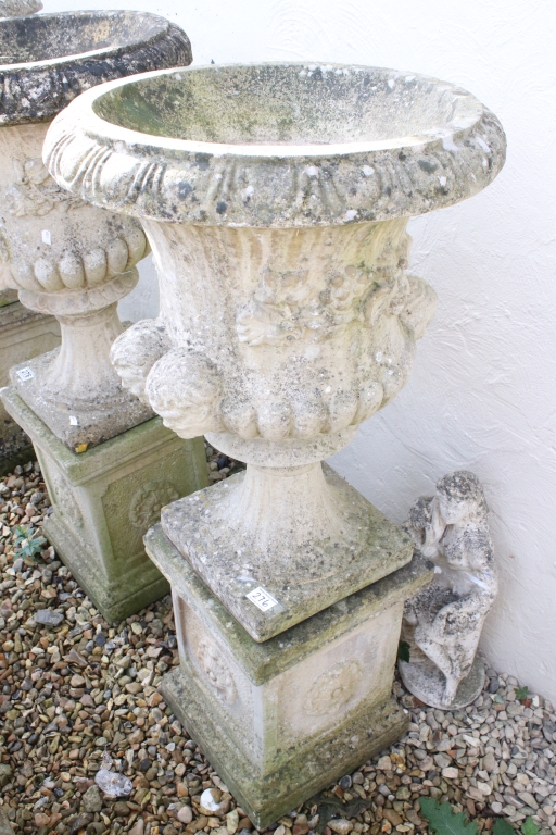 Pair of reconstituted stone garden urns of campana form, with relief facial mask decoration and - Image 2 of 5