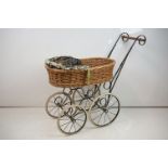 Wicker & wrought iron dolls pram, with four spoked metal wheels (approx 75cm high)