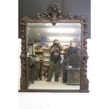 Large 19th century Black Forest style Overmantle Mirror, the framed heavily carved including