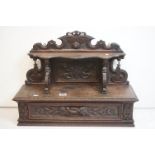 19th century Carved Oak Hanging Cabinet, the shaped back with a shelf over a single drawer, with