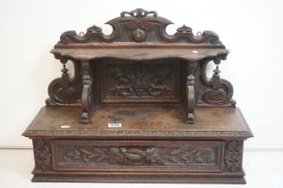 19th century Carved Oak Hanging Cabinet, the shaped back with a shelf over a single drawer, with