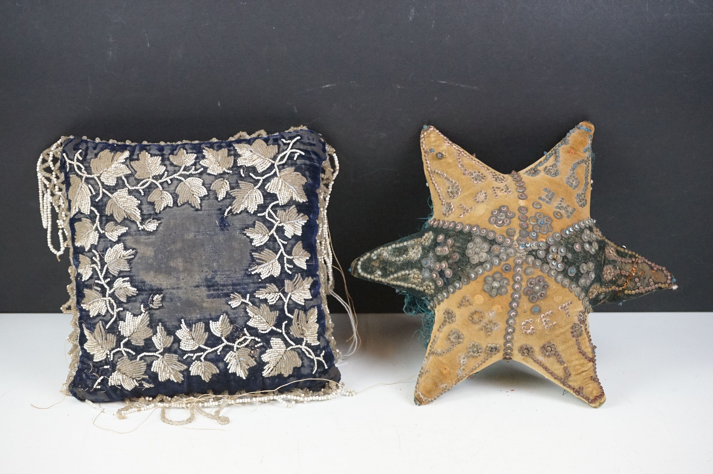 Two 19th Century Victorian beaded pin cushions to include a blue velvet cushion with foliate bead