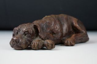 Bronze figurine sculpture in the form of a recumbent great dane dog modelled with crossed paws.