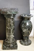 Large black marble baluster vase having a flared neck and round pedestal base, together with a