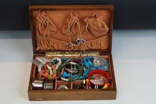 A collection of mixed vintage and contemporary costume jewellery contained within a wooden jewellery